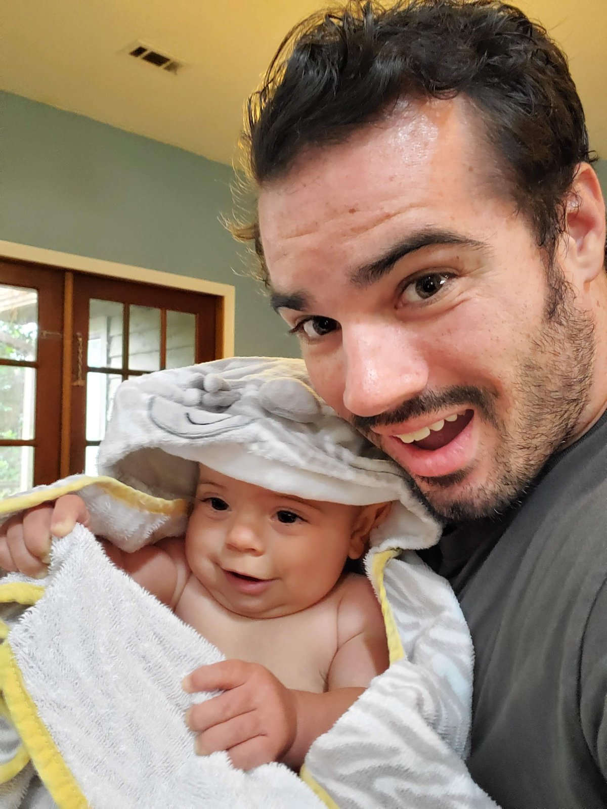 Cole smiling with his daughter after bath time